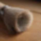 A close-up of a horsehair brush on a wooden table, highlighting its bristles