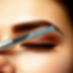 Close-up of a brow razor on a smooth skin surface