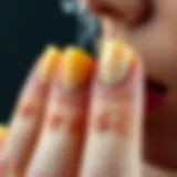 Close-up of yellowed nails due to smoking